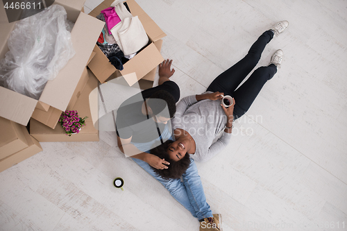 Image of African American couple relaxing in new house