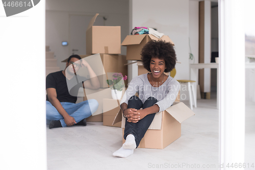 Image of African American couple  playing with packing material