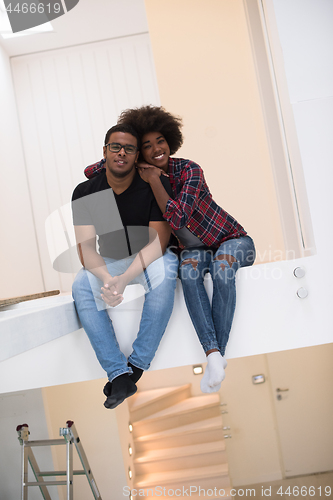 Image of couple having break during moving to new house