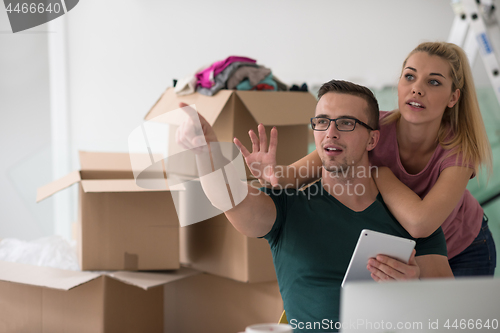 Image of Young couple moving in a new home