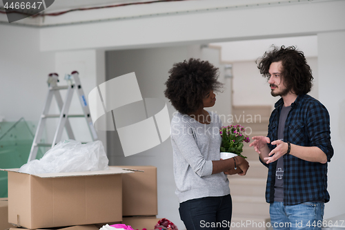 Image of multiethnic couple moving into a new home