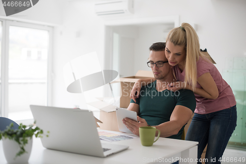 Image of Young couple moving in a new home
