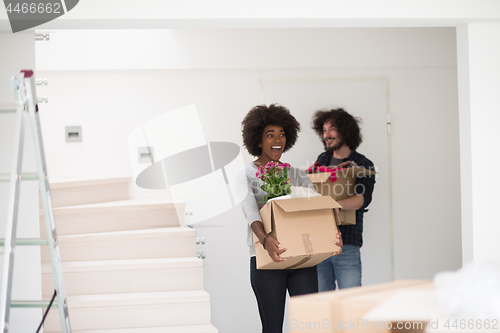 Image of multiethnic couple moving into a new home