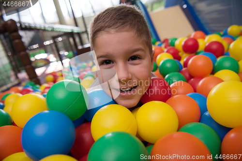 Image of Young mom with her kids in a children\'s playroom