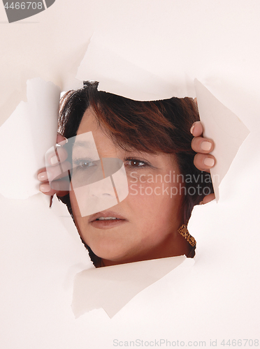 Image of Woman peeking though paper hole