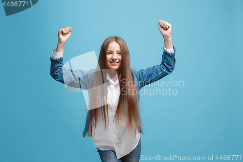 Image of Happy success teen girl celebrating being a winner. Dynamic energetic image of female model