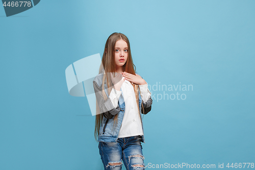 Image of Beautiful teen girl looking suprised isolated on blue