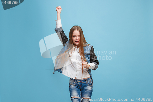 Image of Happy success teen girl celebrating being a winner. Dynamic energetic image of female model