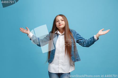 Image of Beautiful teen girl looking suprised and bewildered isolated on pink