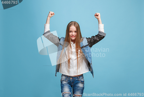 Image of Happy success teen girl celebrating being a winner. Dynamic energetic image of female model