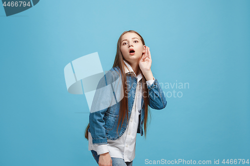 Image of The happy teel girl standing and listening