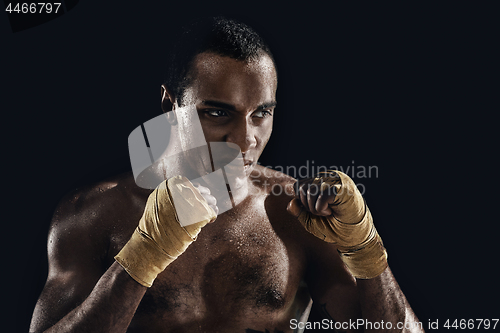 Image of Afro man boxing and training over black background