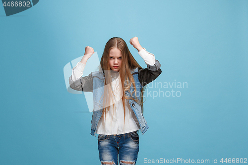 Image of Portrait of an angry woman looking at camera isolated on a blue background