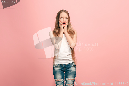 Image of Beautiful teen girl looking suprised isolated on pink