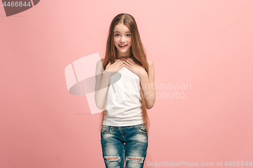 Image of Beautiful teen girl looking suprised isolated on pink