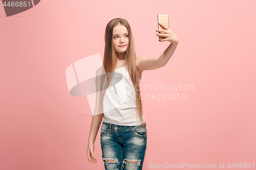 Image of The happy teen girl making selfie photo by mobile phone