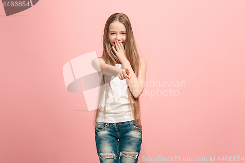 Image of The happy teen girl pointing to you, half length closeup portrait on pink background.