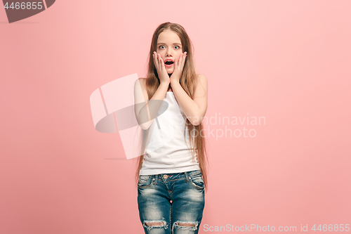 Image of Beautiful teen girl looking suprised isolated on pink