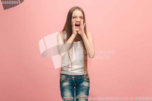 Image of young casual teen girl shouting at studio