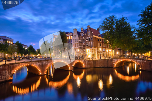 Image of Amterdam canal, bridge and medieval houses in the evening