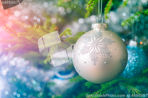 Image of Christmas-tree decoration bauble on decorated Christmas tree bac