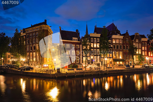 Image of Amterdam canal, bridge and medieval houses in the evening