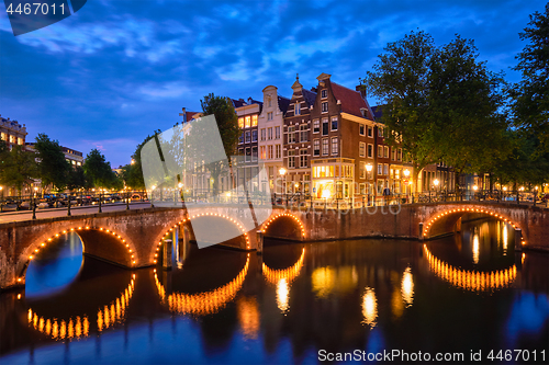 Image of Amterdam canal, bridge and medieval houses in the evening