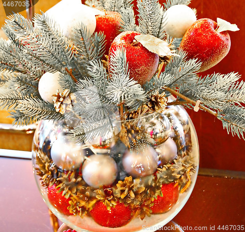 Image of Christmas holidays composition with red apples, silver balls, andglass vase