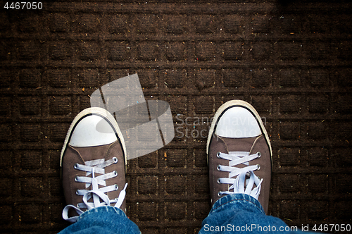 Image of looking down at dirty door mat