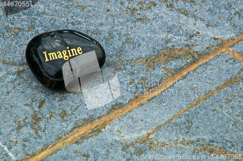 Image of Black Imagine rock on blue soapstone