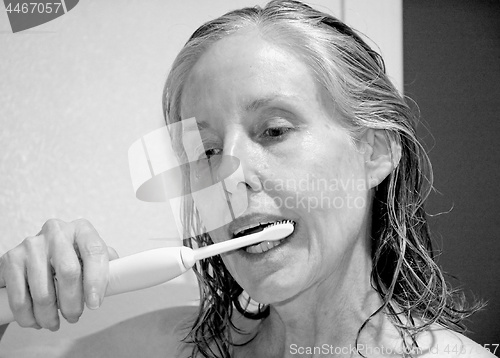 Image of Female beauty brushing her teeth.