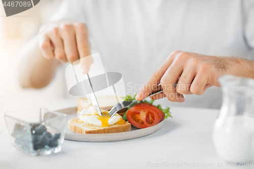 Image of close up of man having toasts for breakfast