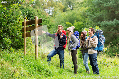 Image of hiking friends with backpacks at signpost