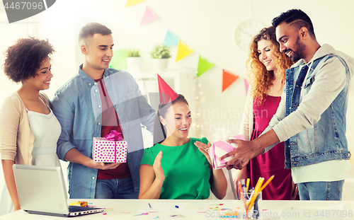 Image of team greeting colleague at office birthday party