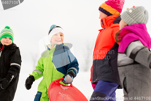 Image of happy little kids with sleds in winter