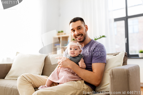 Image of father with little baby girl at home