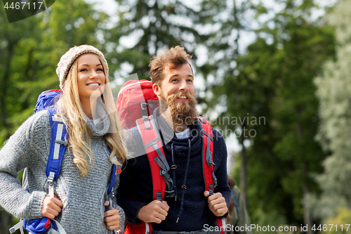 Image of couple of travelers with backpacks hiking