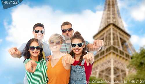Image of friends pointing at you over eiffel tower