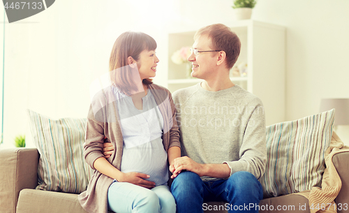 Image of happy pregnant wife with husband at home