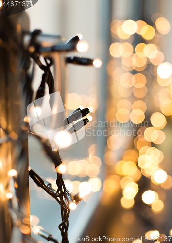 Image of close up of christmas garland on window