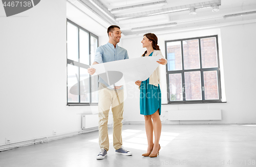 Image of happy couple with blueprint at new home