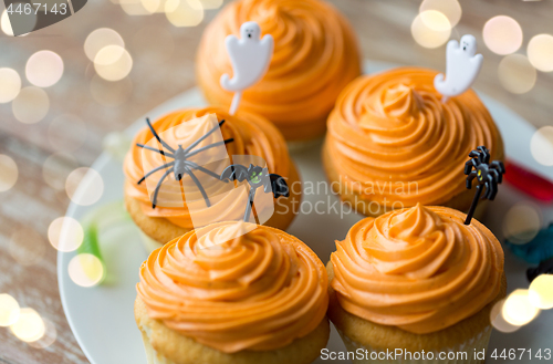 Image of halloween party decorated cupcakes on plate