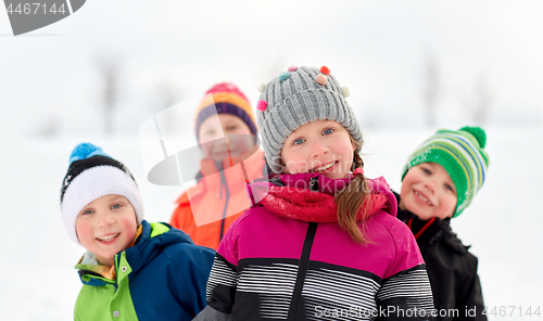 Image of happy little kids in winter clothes outdoors