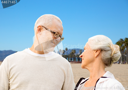 Image of happy senior couple over venice beach background