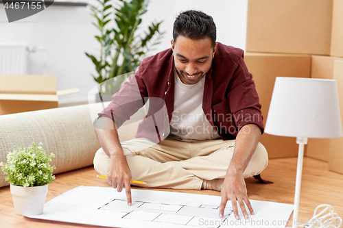 Image of man with boxes and blueprint moving to new home