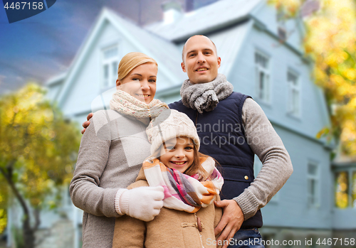 Image of happy family over living house in autumn