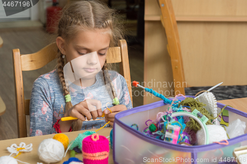 Image of Girl crochets in a classroom at school