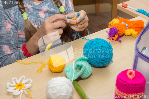 Image of The girl is engaged in needlework in the classroom
