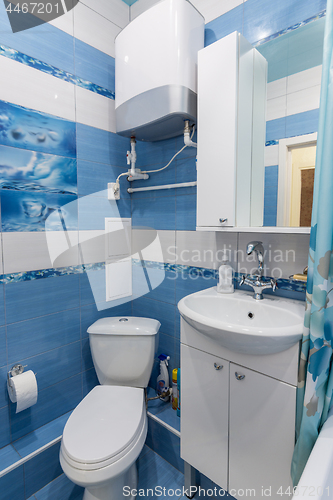 Image of Interior of a small bathroom, toilet, wash basin, boiler