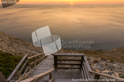 Image of Ladder going down to the sea at sunset, Anapa, Russia